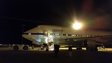 Color photo of a 747 on a taxiway at night.