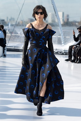 A model in black-blue dress and black gloves at the Alexander McQueen spring 2023 fashion show