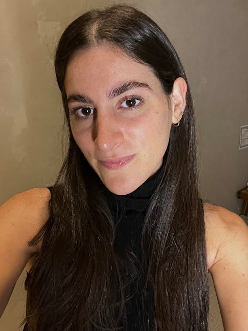 A girl with fluffy and feathered brow arches taking a selfie