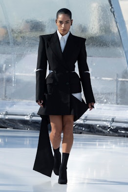 A model in a black-and-white suit-dress at the Alexander McQueen spring 2023 fashion show