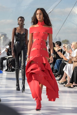 A model in a red strap dress at the Alexander McQueen spring 2023 fashion show