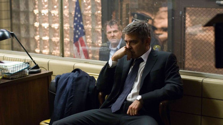 Tom Wilkinson looks at George Clooney through a glass window in Michael Clayton
