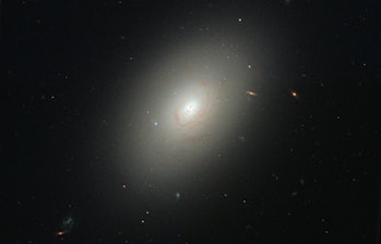 An oval shaped galaxy that is very sparsely filled with stars