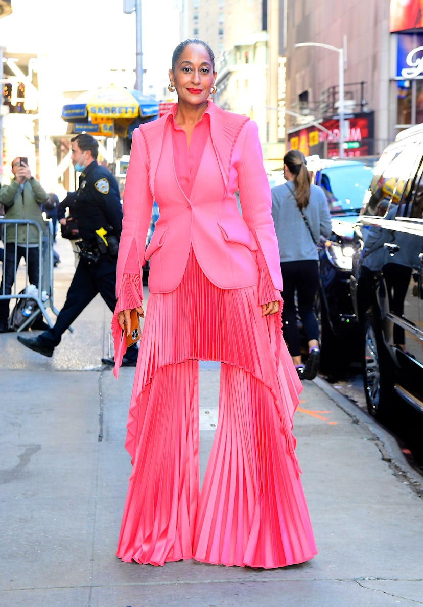Tracee Ellis Ross wearing a pleated bright pink skirt in Manhattan