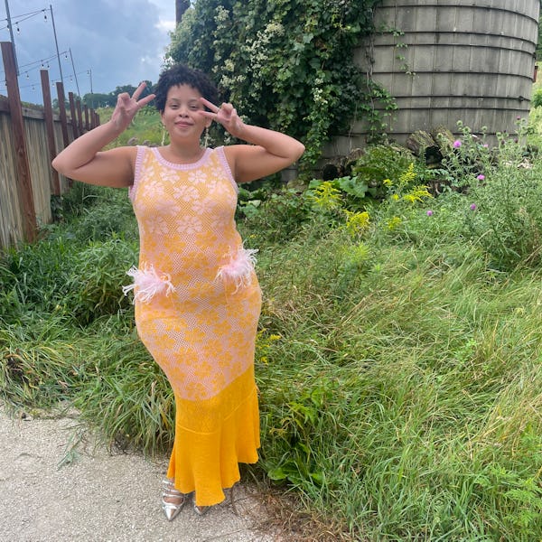 Natasha Marsh posing in a yellow wedding guest dress