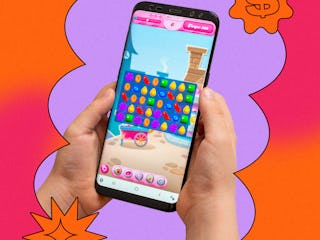 A person playing a game called Candy Crush on a mobile phone