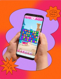 A person playing a game called Candy Crush on a mobile phone