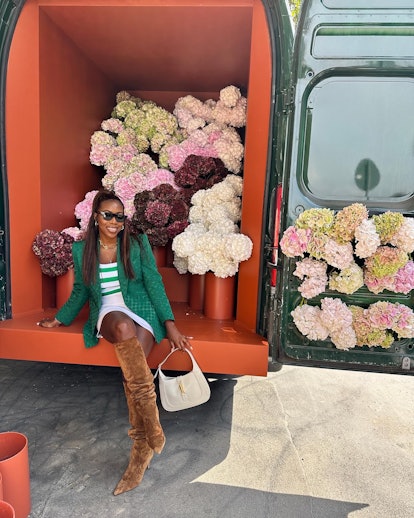 Tiffany Reid wearing the green Gucci blazer while posing in a flower truck.