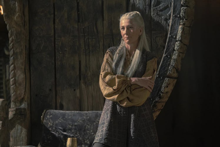 Eve Best as Rhaenys Targaryen with her arms crossed as shes disguised as a commoner