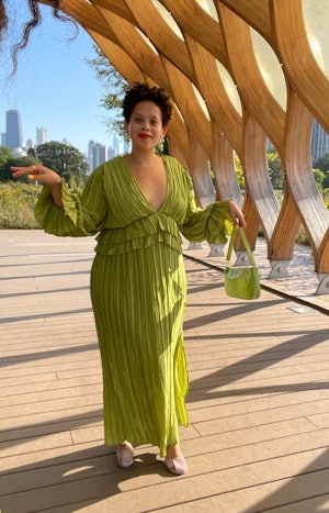 Natasha Marsh posing in a light green wedding guest dress outfit