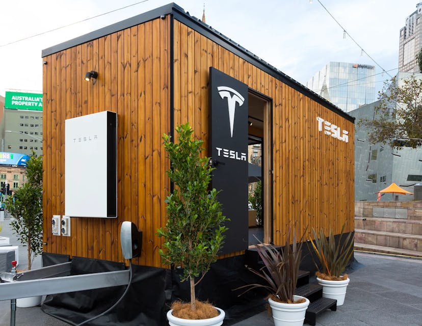 The wooden outside of the Tesla Tiny House with the Tesla logo