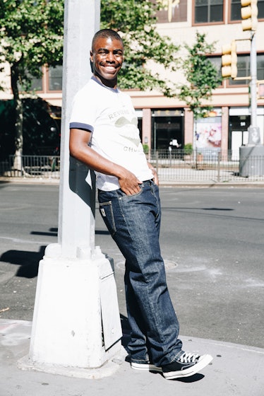 Tyrell Hampton wearing a white t-shirt, denim jeans and sneakers.