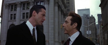 Keanu reeves as kevin and al pacino as the devil staring each other down in the movie The Devils Adv...
