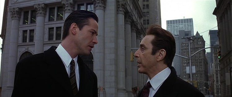 Keanu reeves as kevin and al pacino as the devil staring each other down in the movie The Devils Adv...
