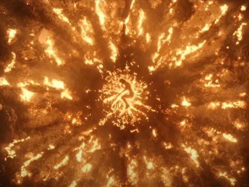 Flames bursting around  a body lying on the ground, a scene from 'Rings of Power'