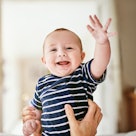 A baby waving.