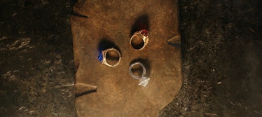The Three Rings rest on a wooden board in the Season 1 finale of The Lord of the Rings: The Rings of...