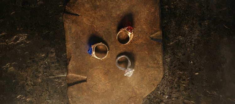 The Three Rings rest on a wooden board in the Season 1 finale of The Lord of the Rings: The Rings of...