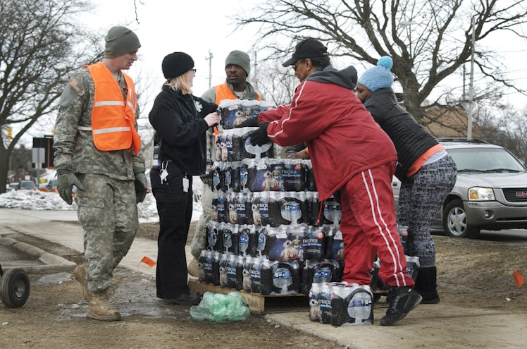 Volunteers distribute bottled water in the city of Flint