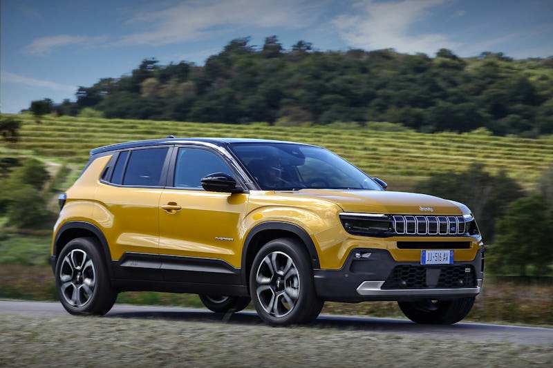 A yellow Jeep Avenger electric SUV parked in nature