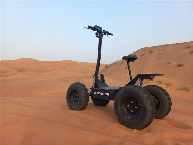 Robo.Systems' Gladiator e-scooter parked on sand