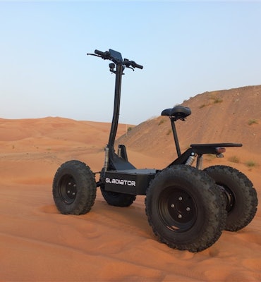 Robo.Systems' Gladiator e-scooter parked on sand