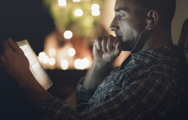 A man watching porn on his tablet