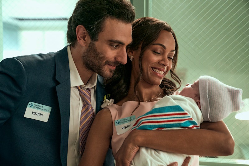Eugenio Mastrandrea as Lino Ortolano and Zoe Saldana as Amy Wheeler hold their daughter in Episode 6...