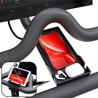 This Peloton phone mount is a tray that can hold your phone and accessories.