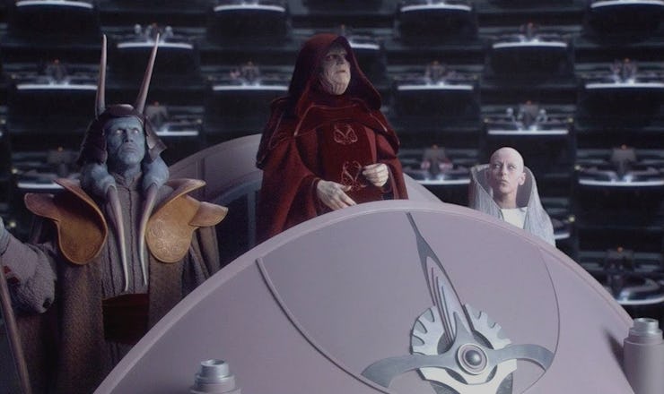 Palpatine wearing red clothes in a scene from the Star Wars movie