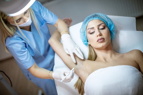 A woman during the Botox treatment for underarm sweating