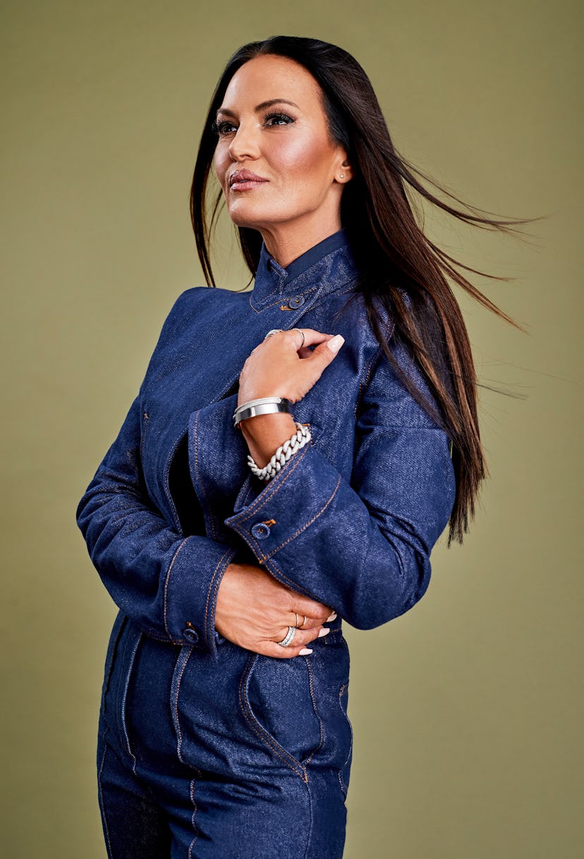 Lisa Barlow  posing in a denim blue dress and looking into the distance