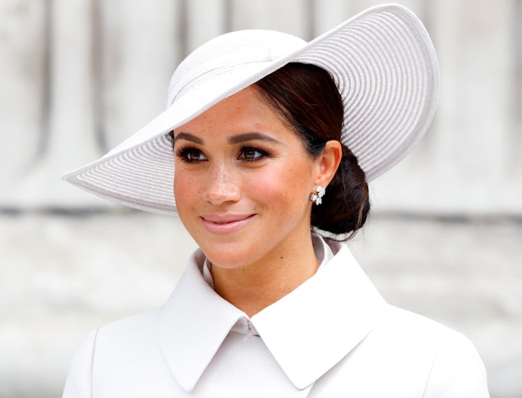 A photo of Meghan Markle, wearing a white outfit and hat