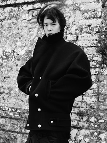 Seng Khan wears a black wool coat.