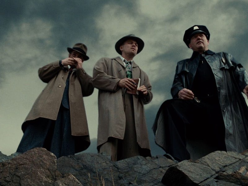 Mark Ruffalo and Leonardo DiCaprio stand on a ledge of rocks in 2010's Shutter Island