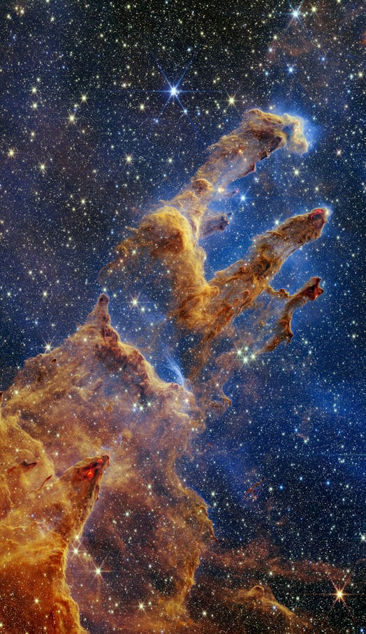 Pillars of Creation image from JWST, with lots of stars and pillars of dust that look like a hand re...