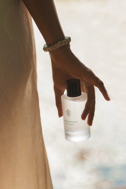 Crown Affair hair perfume in hand