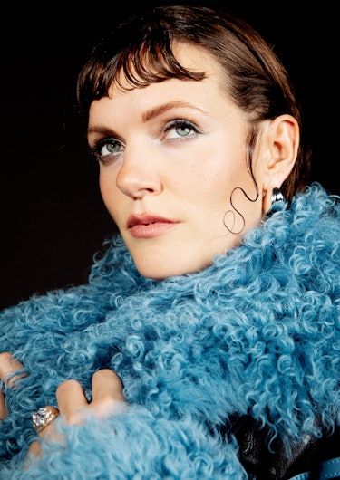 Close-up of Tove Lo wearing a blue coat white looking in the distance