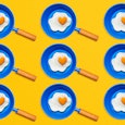 An illustration of nine blue pans with fried eggs 