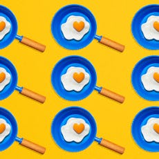An illustration of nine blue pans with fried eggs 