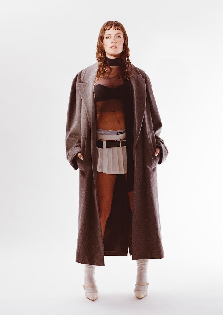 Tove Lo wearing a brown coat posing for the camera