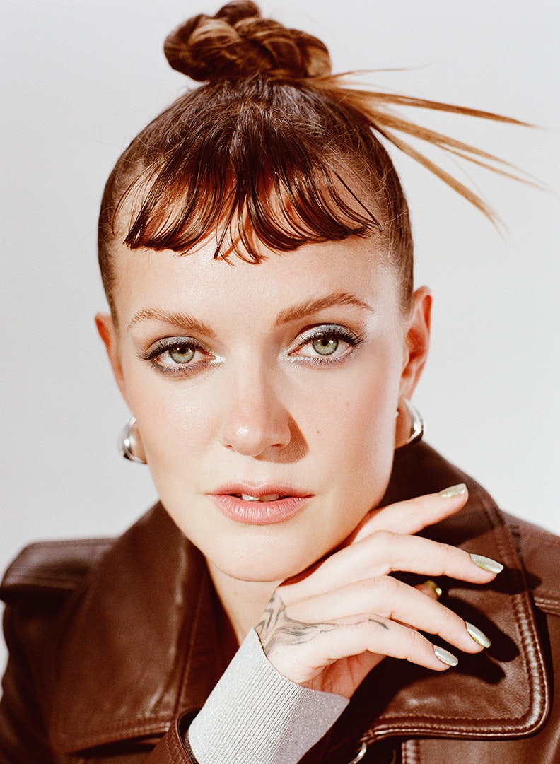 Tove Lo wearing a brown jacket while looking at the camera