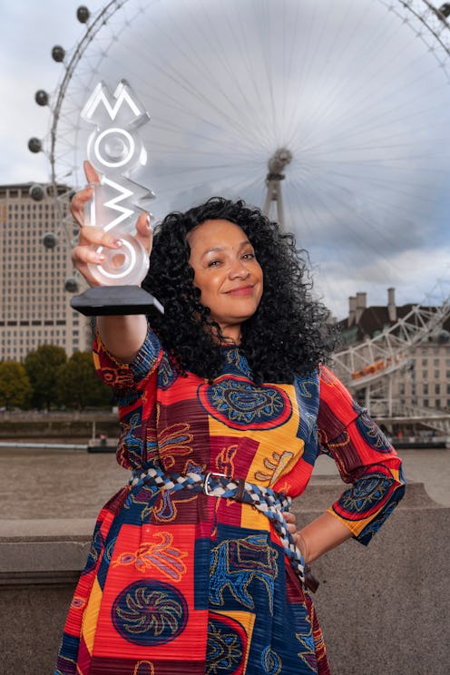 MOBO founder Kanya King holding award in front of London Eye