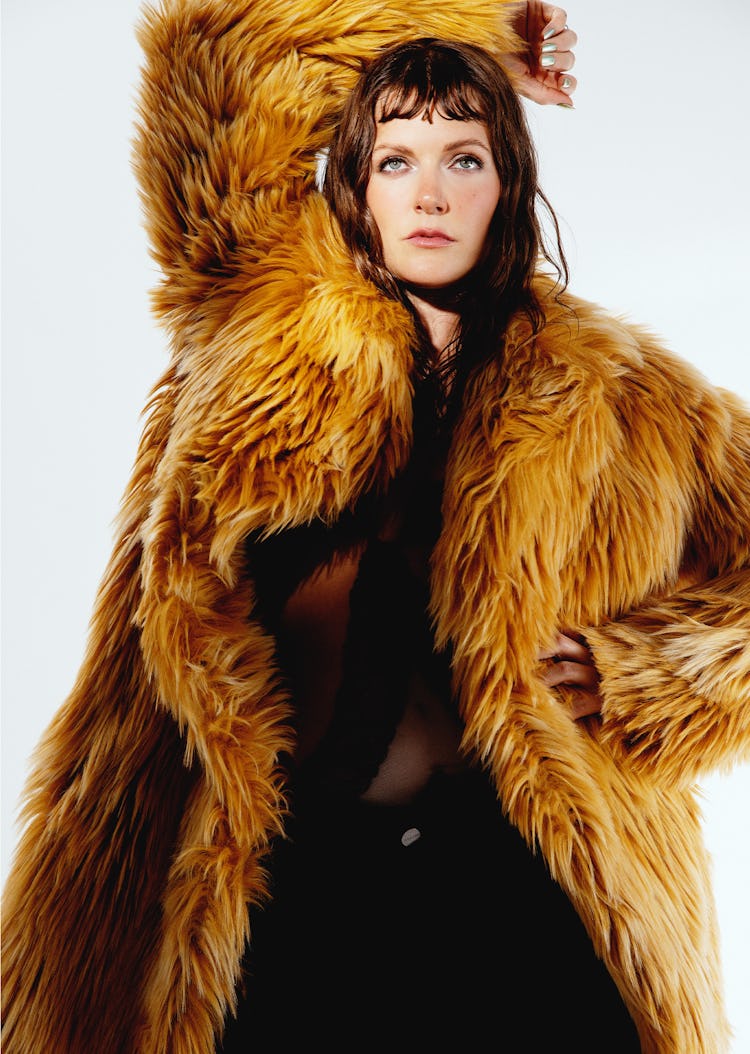 Tove Lo wearing an orange fur coat posing for the camera