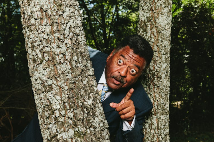 Sammy Stephens has fully spread eyes while peeking out of two tree branches