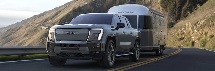 The third fully-electric truck Sierra EV Denali in grey color being ridden on the road 