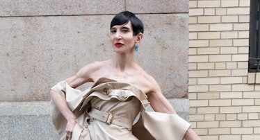 Amy Fine Collins wears a Burberry dress; her own jewelry and shoes.