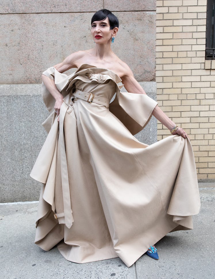 Amy Fine Collins wears a Burberry dress; her own jewelry and shoes.