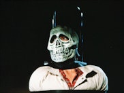 A scene from the movie Halloween III: Season of the Witch with a man wearing a skull mask