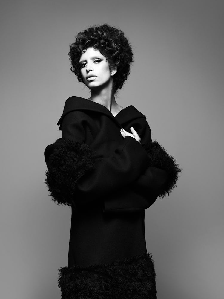 Model wears a black wool coat.